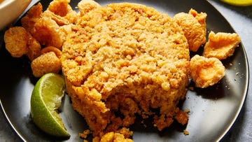 fried plantains mashed with pork cracklings and shaped into a circle, served with pork cracklings and a lime wedge