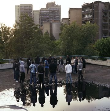a group of people standing on a bridge over a body of water