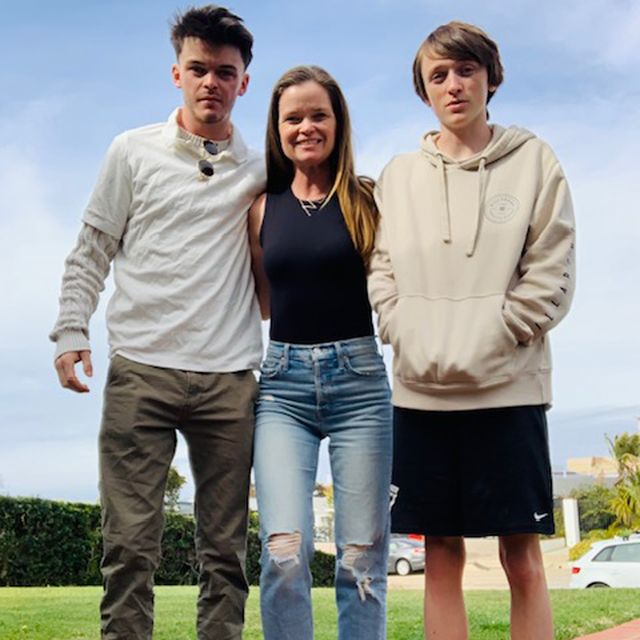 moira clark takes a picture with her two sons