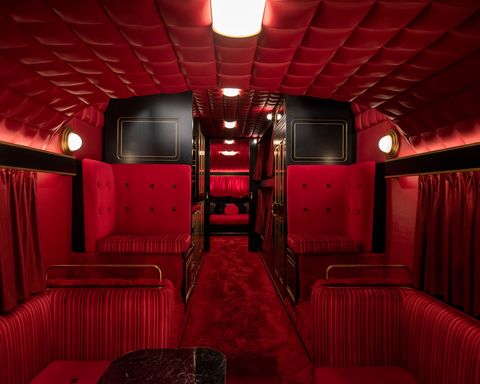 inside an all red tour bus with red seats and walls