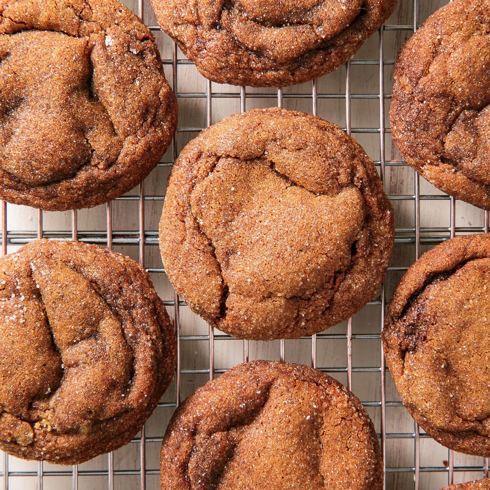 cakey molasses cookies that have been rolled in granulated sugar sitting on a cooling rack