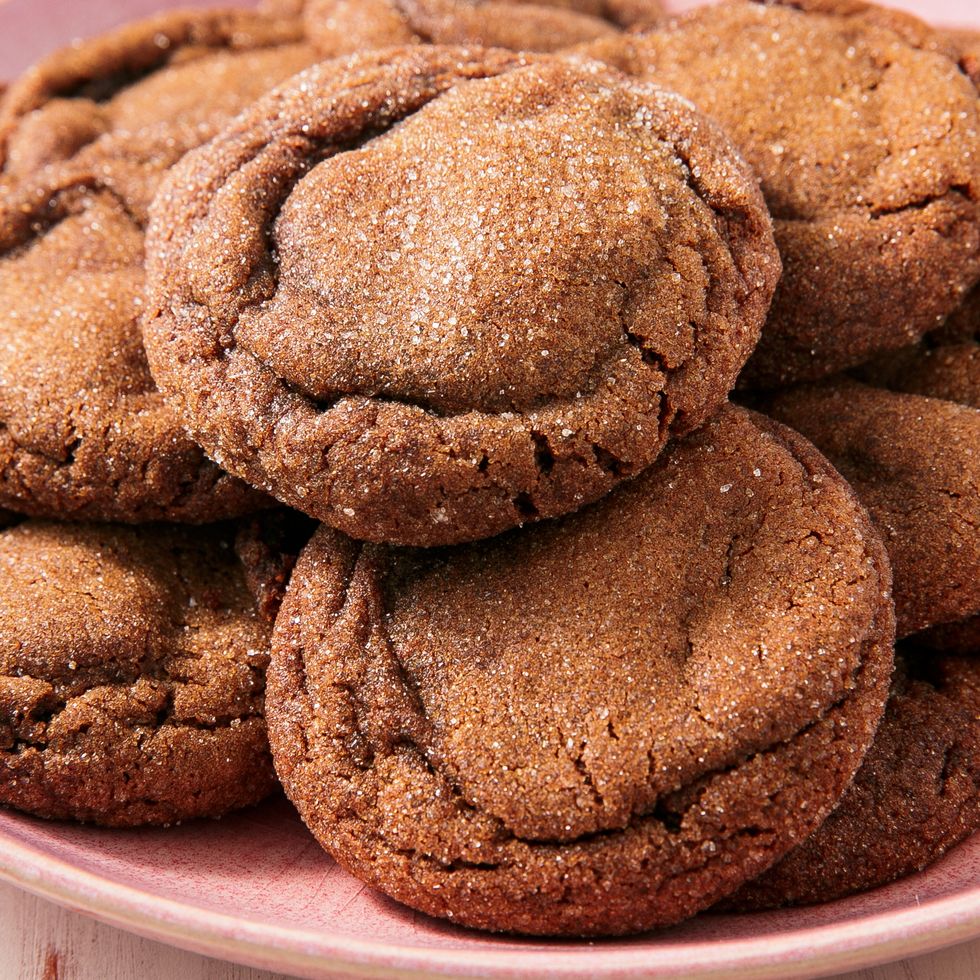 cakey molasses cookies that have been rolled in granulated sugar sitting on a cooling rack