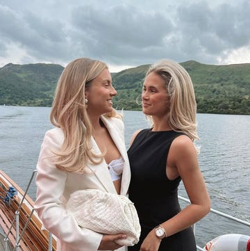 Zoe Rae and Molly Mae two women posing together on a boat with a scenic lake backdrop