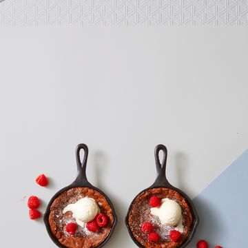 molten chocolate skillet brownies with ice cream and raspberries on top