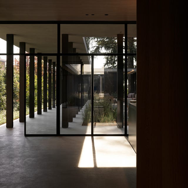 moody exterior with glass wall and long columned walkway