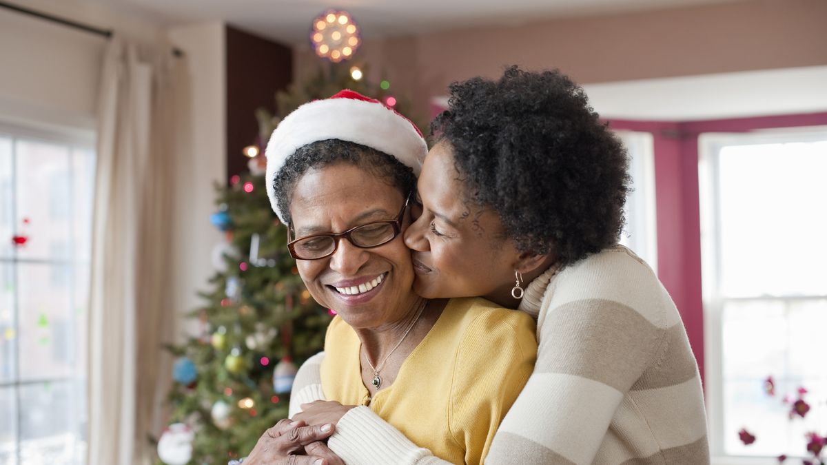 https://hips.hearstapps.com/hmg-prod/images/mom-and-adult-daughter-hugging-at-christmas-tree-royalty-free-image-1666202718.jpg?crop=1xw:0.84554xh;center,top&resize=1200:*