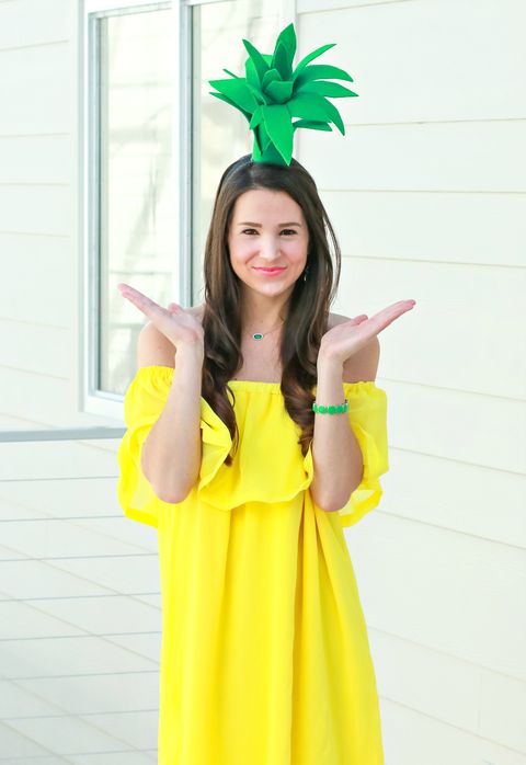 mom halloween costume with yellow dress and green hat that looks like top of pineapple