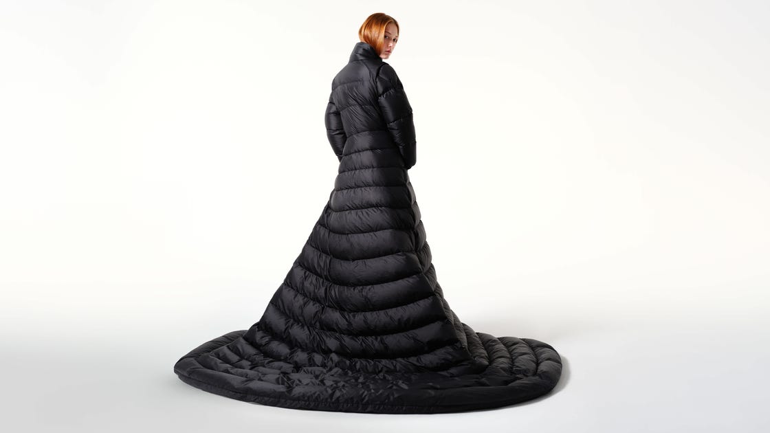 a long black puffer coat with a floorlength train