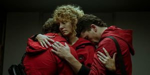 money heist part 4 still of three characters, including rio, hugging