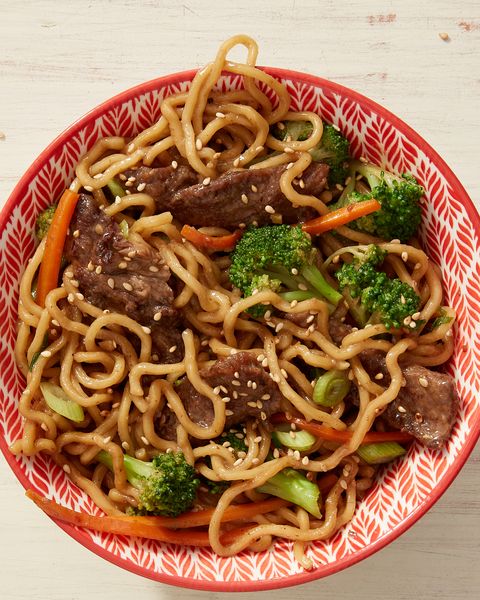 a big bowl of ramen noodles topped with juicy meatballs and broccoli