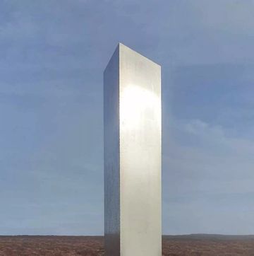 a white pillar in a field