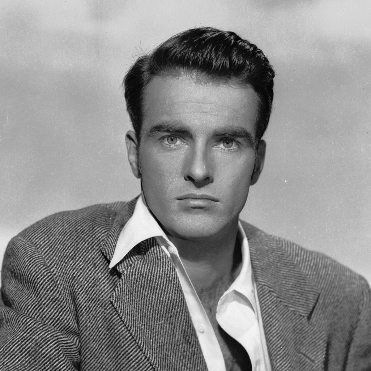 Montgomery circa 1950: American actor Montgomery Clift (1920 - 1966) leaning on a fence with an intent expression. (Photo via John Kobal Foundation/Getty Images)