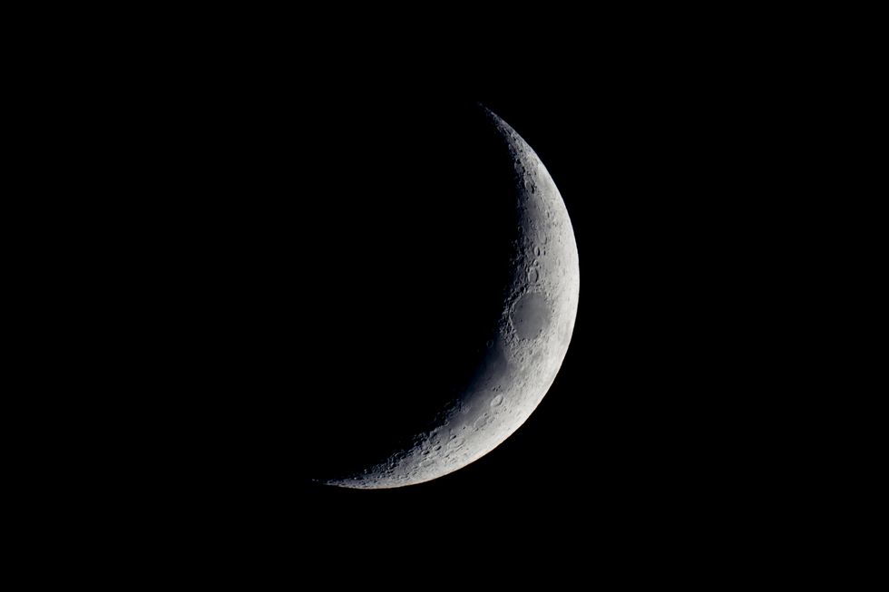 close up of crescent moon against a black sky