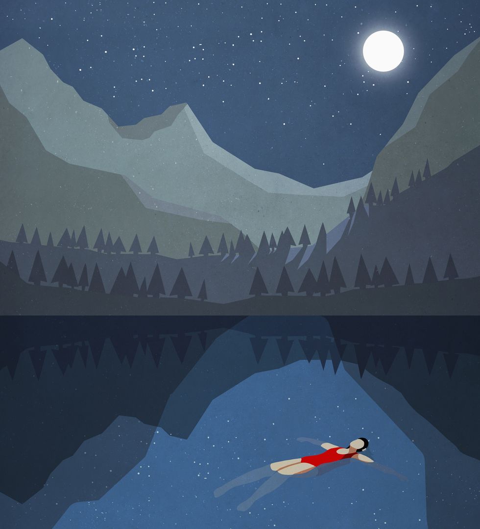 moonlight shining over serene woman floating on back in tranquil mountain lake