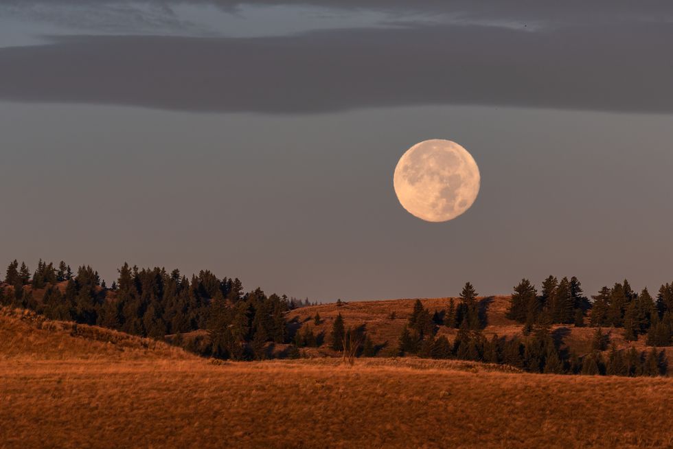 harvest moon over farmland in kamloops, british columbia, the full moon closest to the autumn equinox and first day of fall