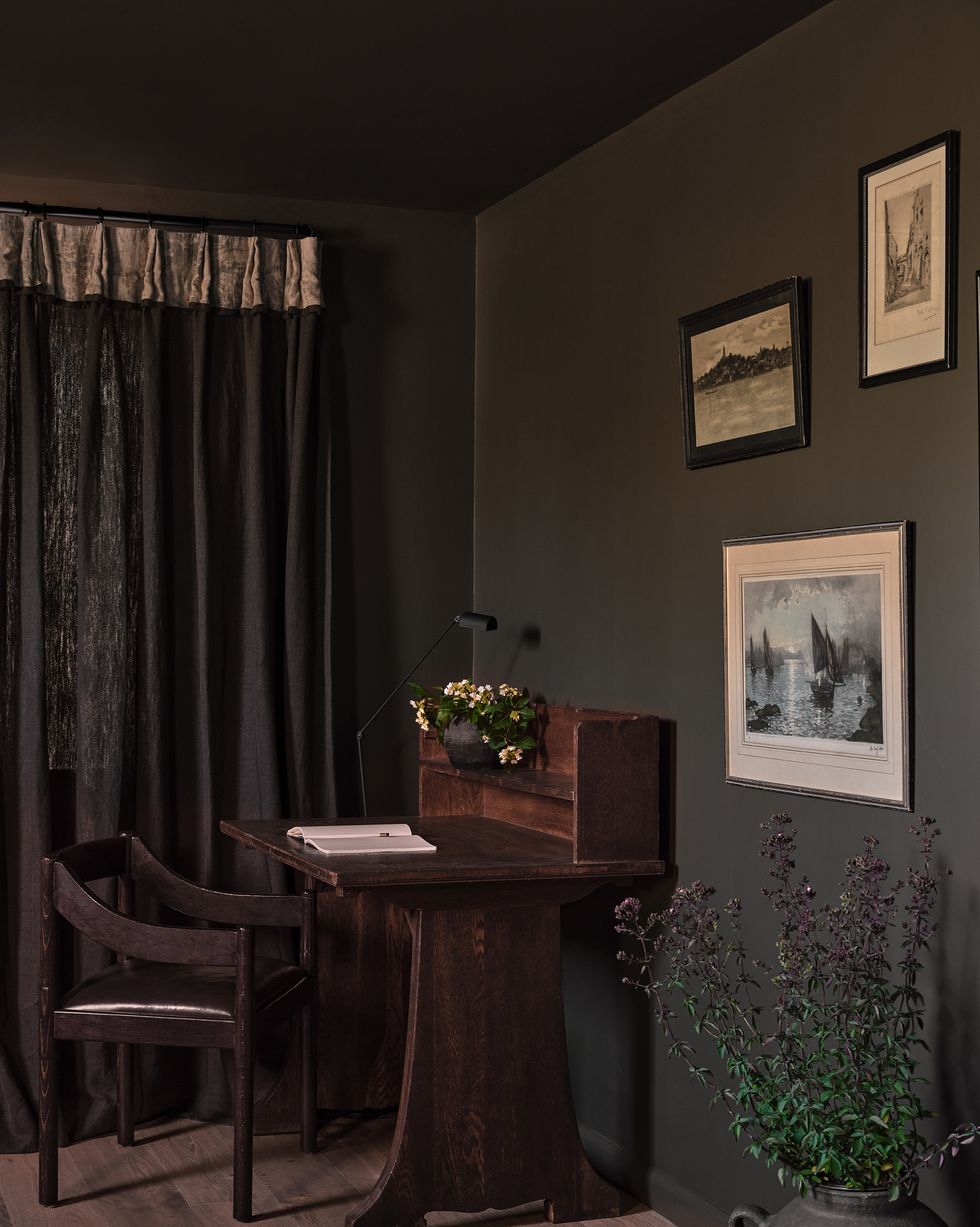 writing desk and chair in the corner of a bedroom