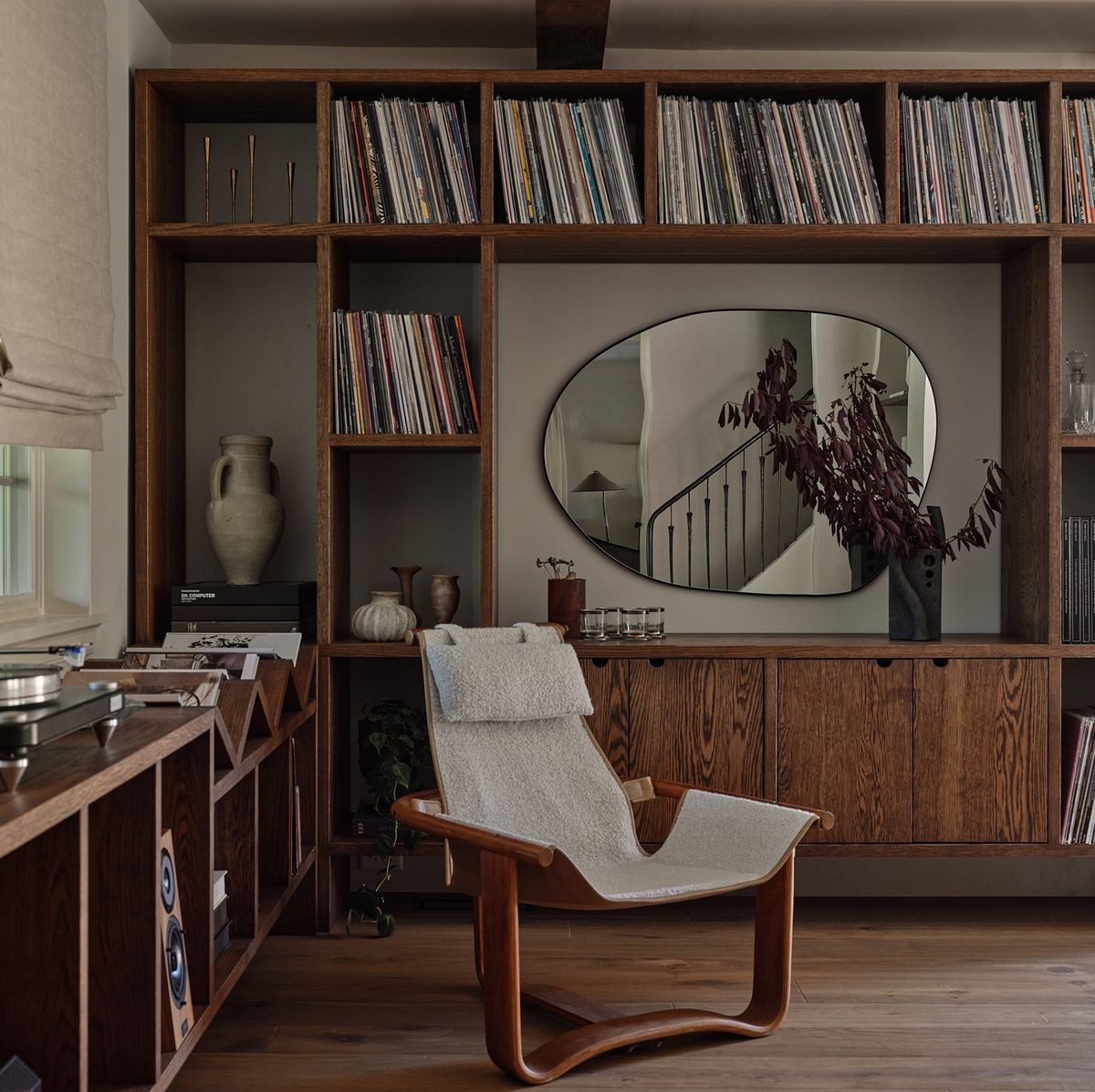 sitting area with chair and shelves filled with records