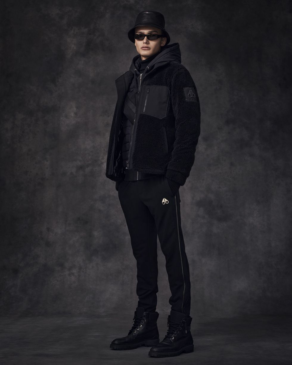 Black, Clothing, Standing, Outerwear, Fashion, Jacket, Hood, Human, Trousers, Darkness, 