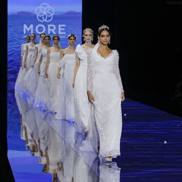 a group of people in white dresses