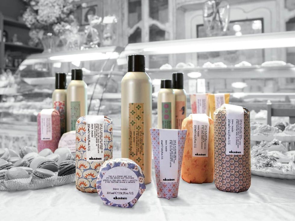 multi colored and patterned davines haircare and styling products on a black and white background