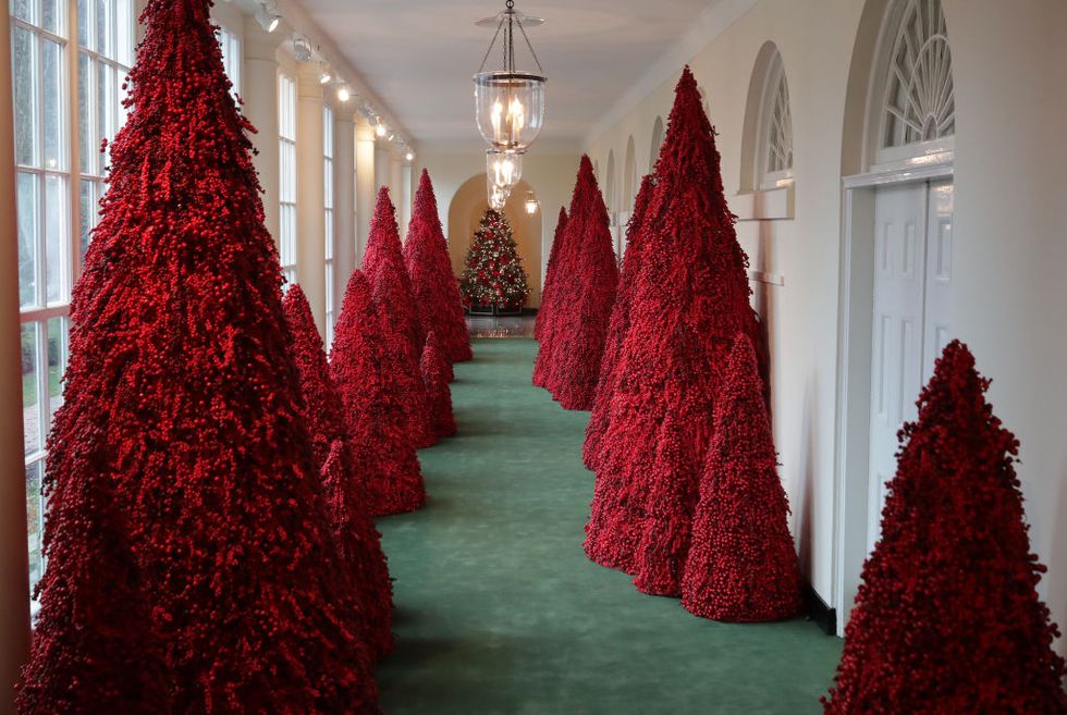 More than 40 red topiary trees line the East colonnade as part of the holiday decorations at the White House November 26, 20