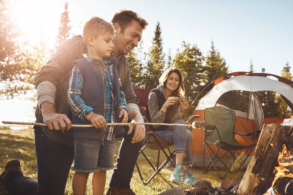 summer activities with a family camping near a fire pit