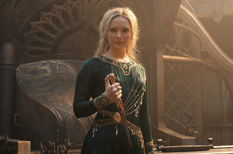 morfydd clark as galadriel in a green dress holding a dagger, lord of the rings the rings of power