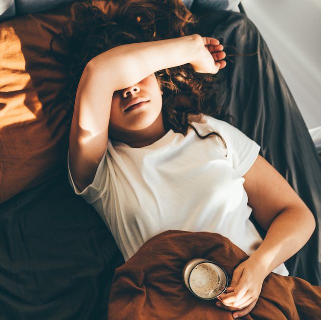 morning anxiety top view of woman laying on bed in bad mood unhappy female at home alone