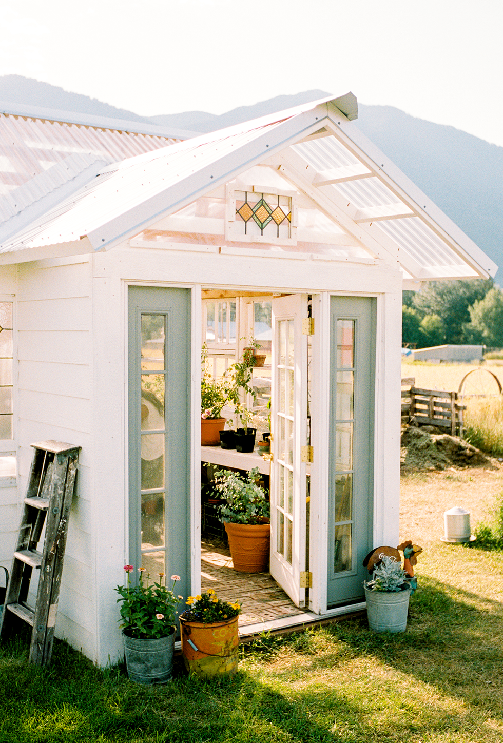 greenhouse with an inviting entryway and various potted plants