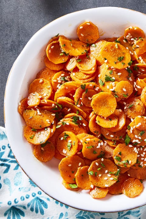 moroccan carrots with chopped herbs in a white bowl