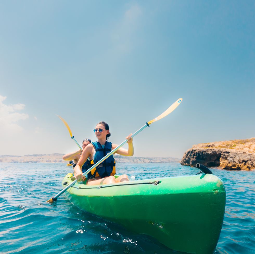 a couple canoeing around the islands of malta