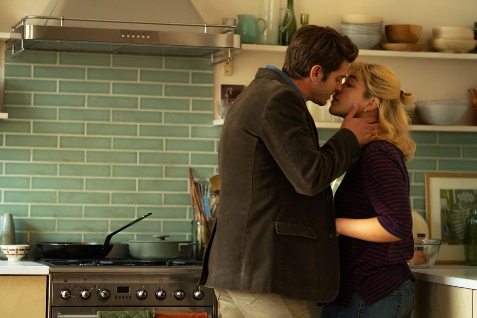 tobias and almut share a kiss in a kitchen in a scene from we live in time