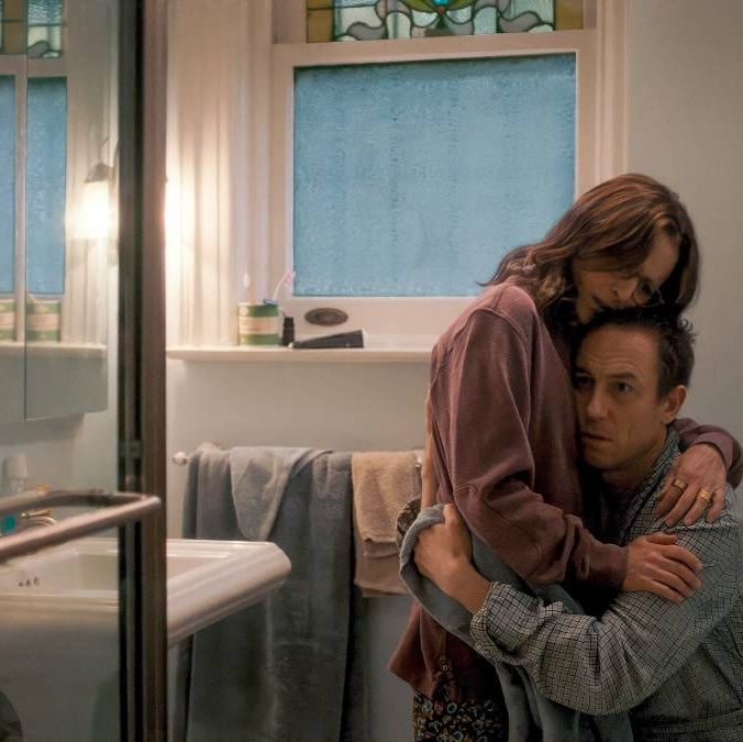 a longtime married couple embraces in a scene from you hurt my feelings