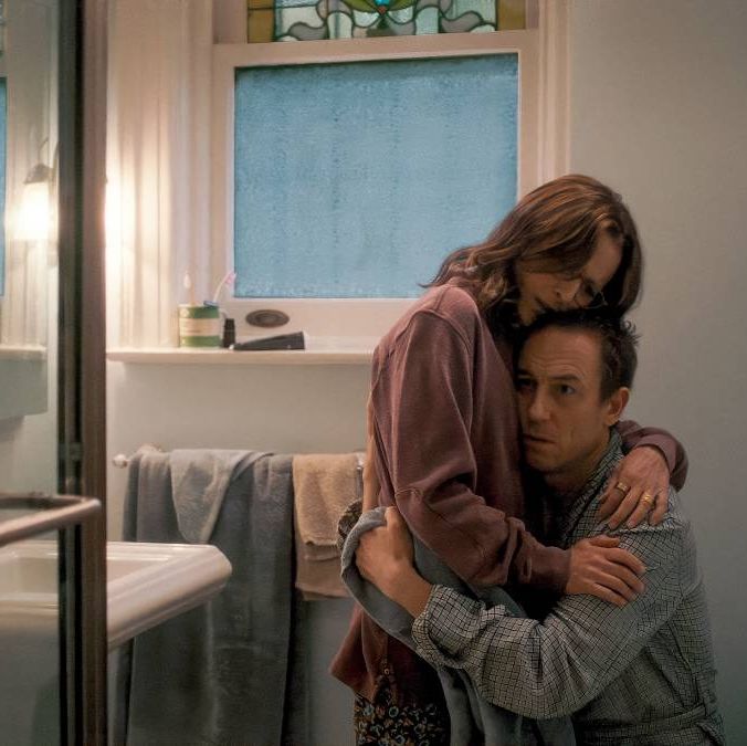 a longtime married couple embraces in a scene from you hurt my feelings