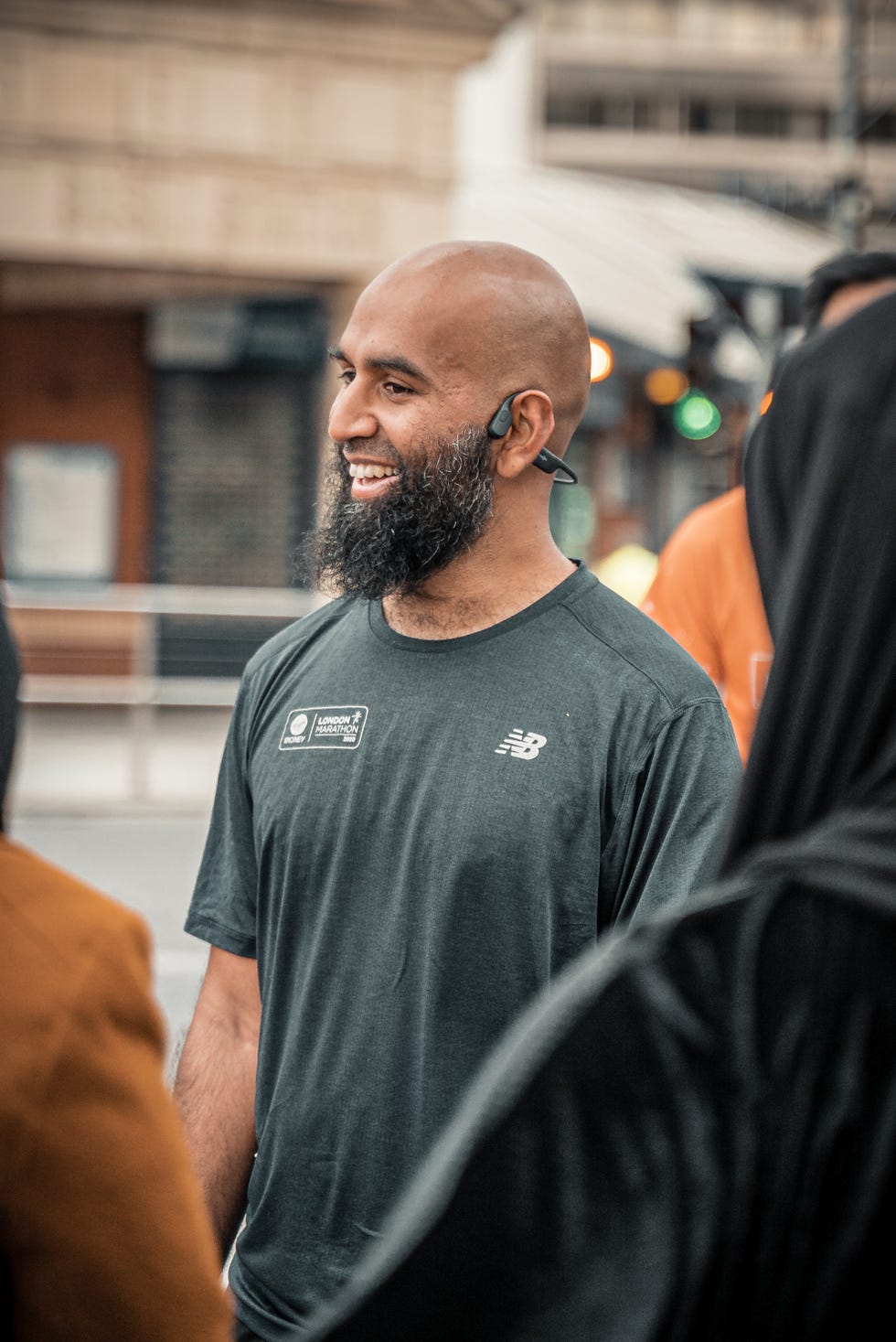 close up of a smiling runner standing among a group