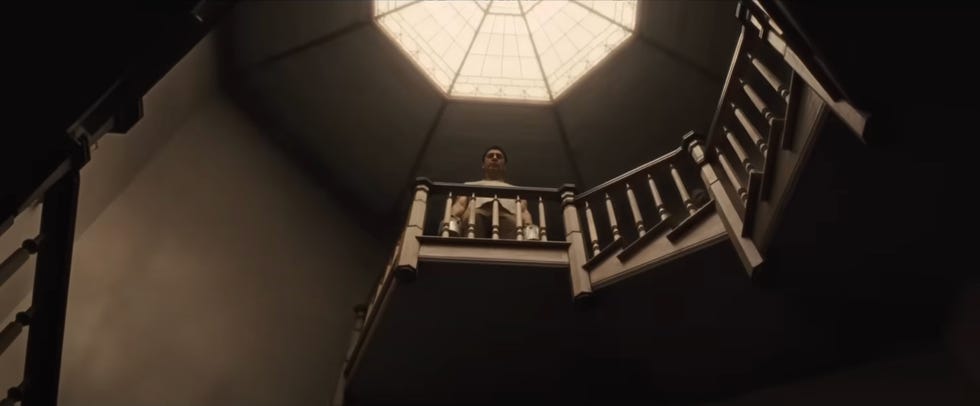 view from the bottom of a staircase looking up towards a skylight