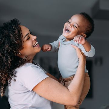 mother and cute baby boy having fun at home.