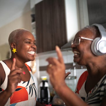 mother and daughter dancing at home