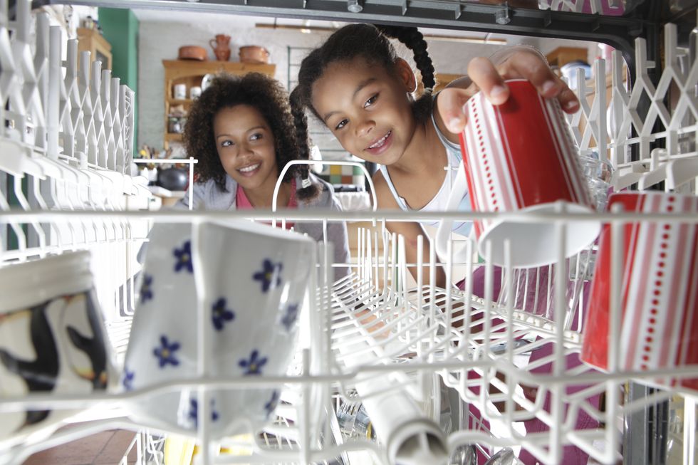 a mother and daughter loading a dishwasher
