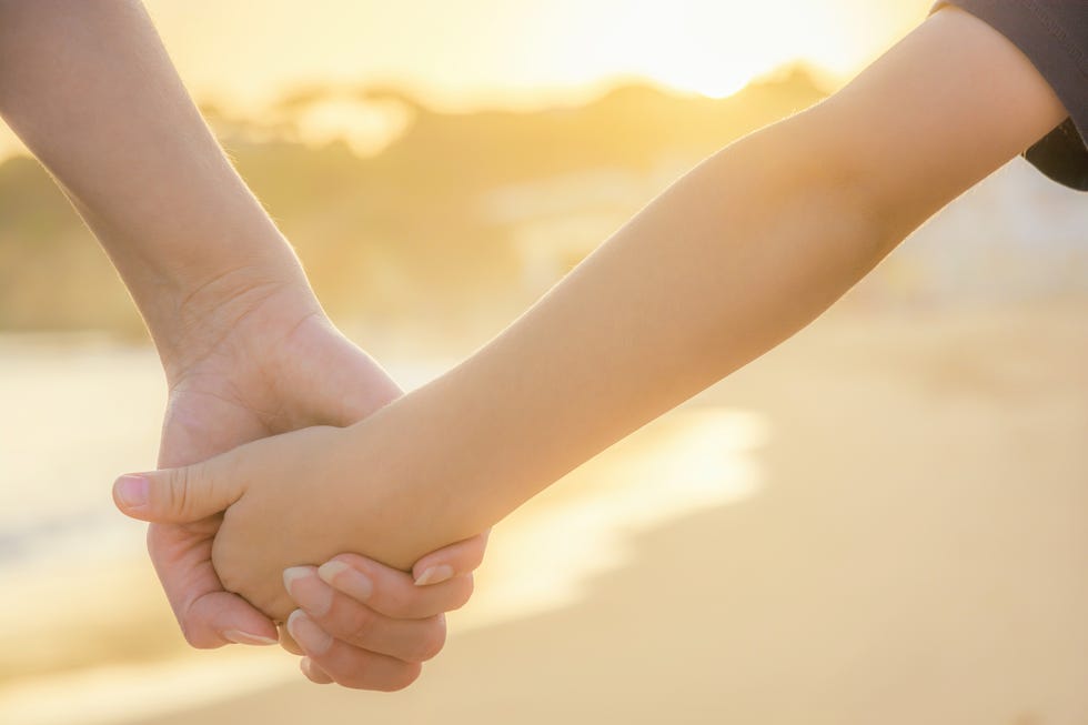 Mother and son holding hands