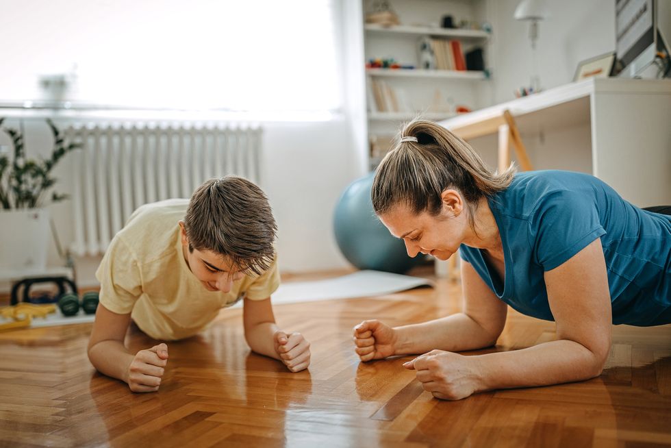 mother and son in plank pose at home