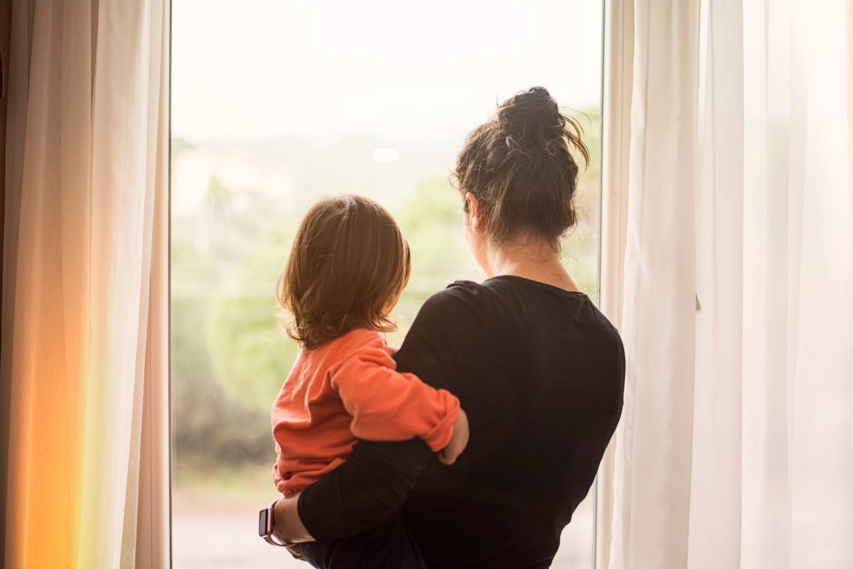 https://hips.hearstapps.com/hmg-prod/images/mother-and-son-looking-out-of-window-royalty-free-image-1680726388.jpg?crop=0.668xw:1.00xh;0.167xw,0&resize=1200:*