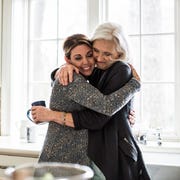 mother and daughter hugging in kitchen mother and daughter hugging in kitchen