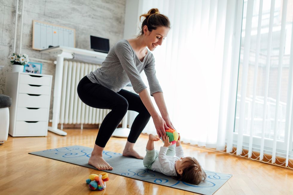 mother exercise with her baby at home
