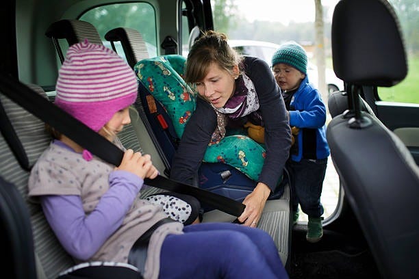 girl in car booster seat