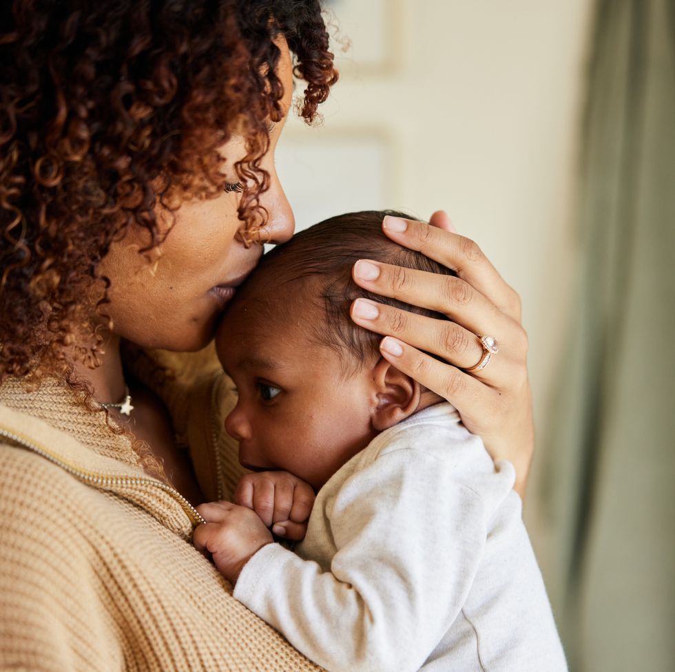 mother kissing with her baby boy in her arms