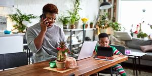 Mother looking after son and working from home