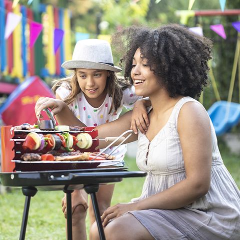 mother and daughter preparing tasty barbecue on back yard bbqing is a gh idea for best mother