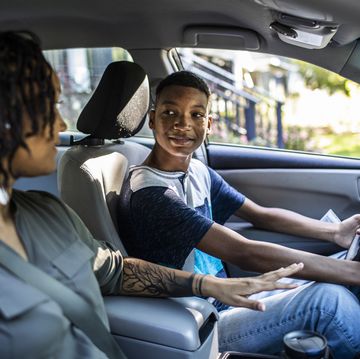 mother teaching teenage son to drive