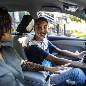 mother teaching teenage son to drive